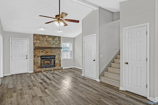 unfurnished living room with a fireplace, hardwood / wood-style floors, ceiling fan, and lofted ceiling