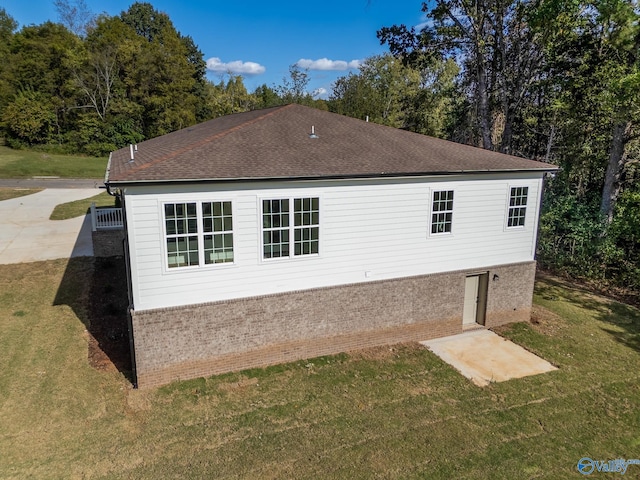 view of property exterior with a yard