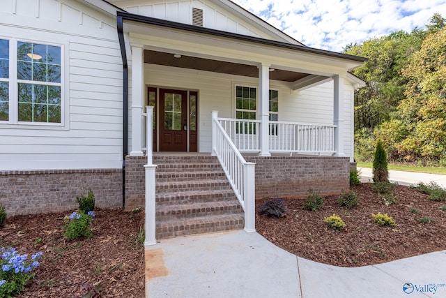 view of exterior entry featuring a porch