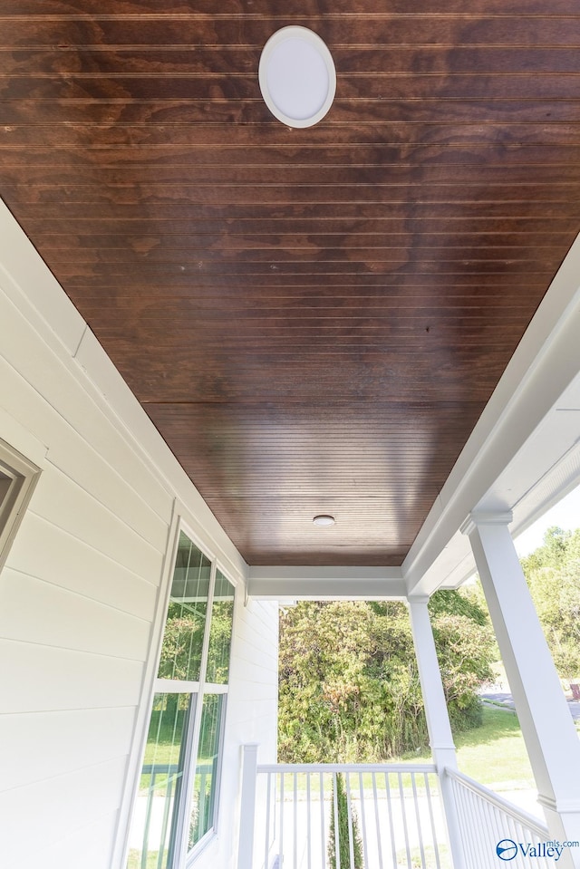 details featuring wood ceiling and wood walls