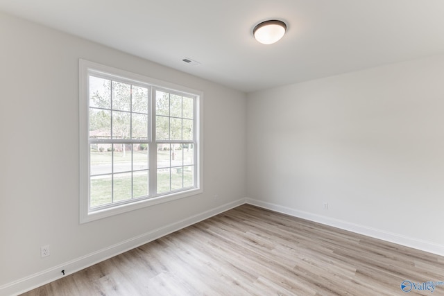 spare room featuring light hardwood / wood-style floors