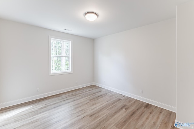 spare room featuring light hardwood / wood-style flooring