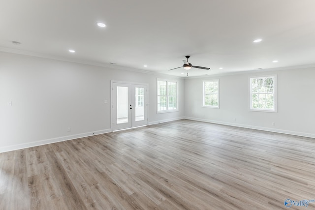 empty room with ornamental molding, french doors, light hardwood / wood-style flooring, and ceiling fan