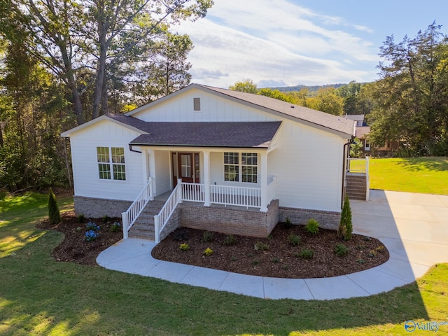 single story home with a front yard and a porch