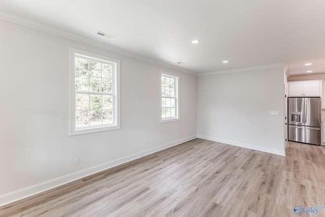 unfurnished room with crown molding and light wood-type flooring