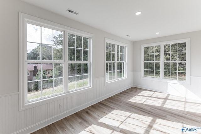 unfurnished sunroom featuring plenty of natural light