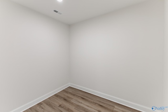 unfurnished room with wood-type flooring