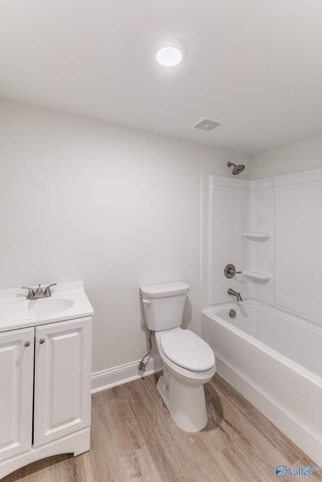 full bathroom featuring vanity, toilet, shower / tub combination, and hardwood / wood-style floors