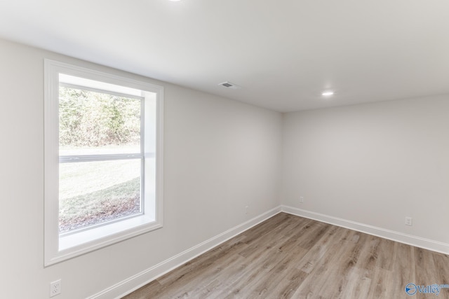 unfurnished room with light hardwood / wood-style floors