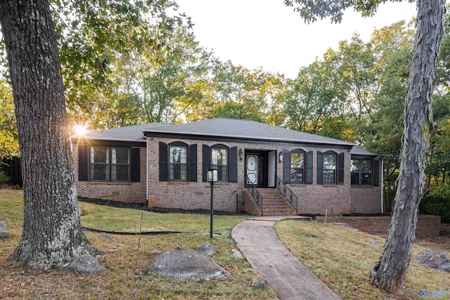 ranch-style house with brick siding and a front lawn