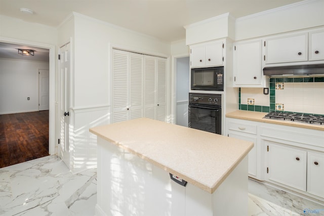 kitchen featuring marble finish floor, black appliances, crown molding, and range hood