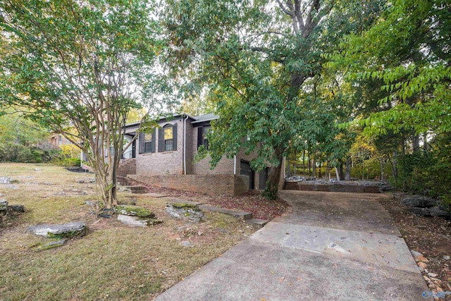 obstructed view of property featuring concrete driveway