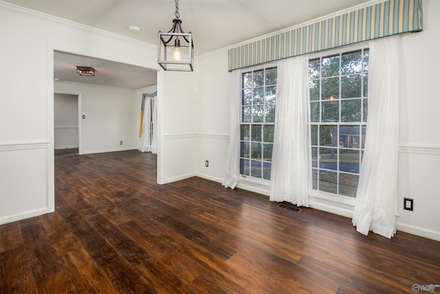 unfurnished dining area with visible vents, crown molding, baseboards, and wood finished floors