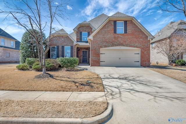 traditional-style home featuring a shingled roof, brick siding, and driveway