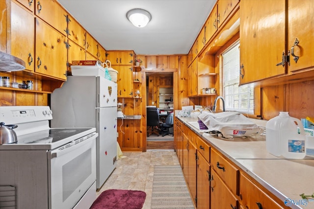 kitchen featuring brown cabinets, white appliances, open shelves, and light countertops