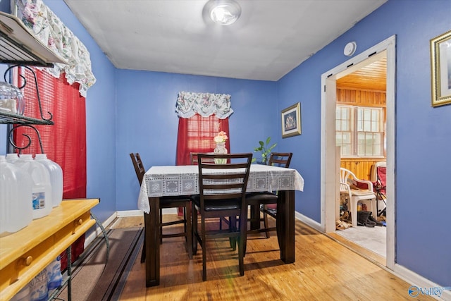 dining area featuring baseboards and wood finished floors