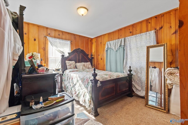 bedroom featuring wood walls and light colored carpet