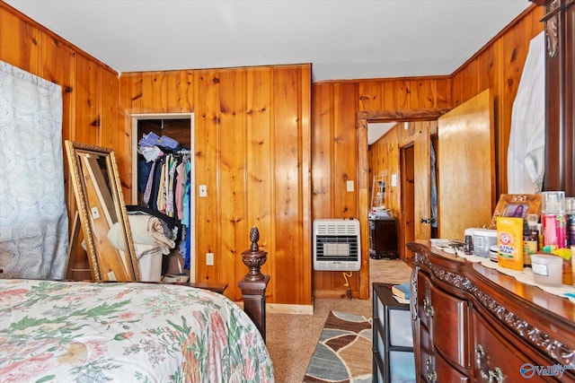 bedroom featuring wood walls, a closet, and heating unit