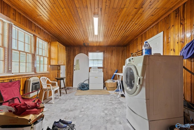 laundry room featuring washer / clothes dryer, plenty of natural light, and wooden walls