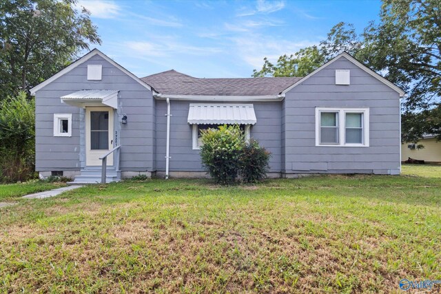 view of side of property with a yard