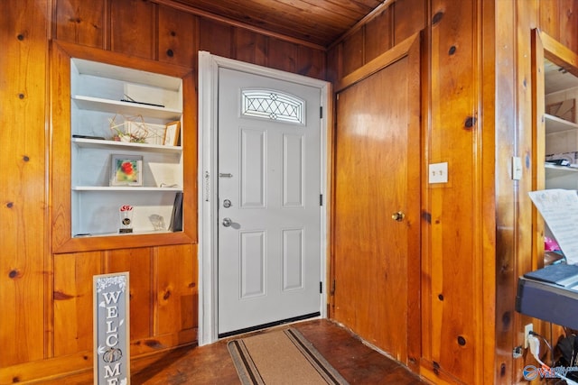 entryway with wood walls and wood ceiling