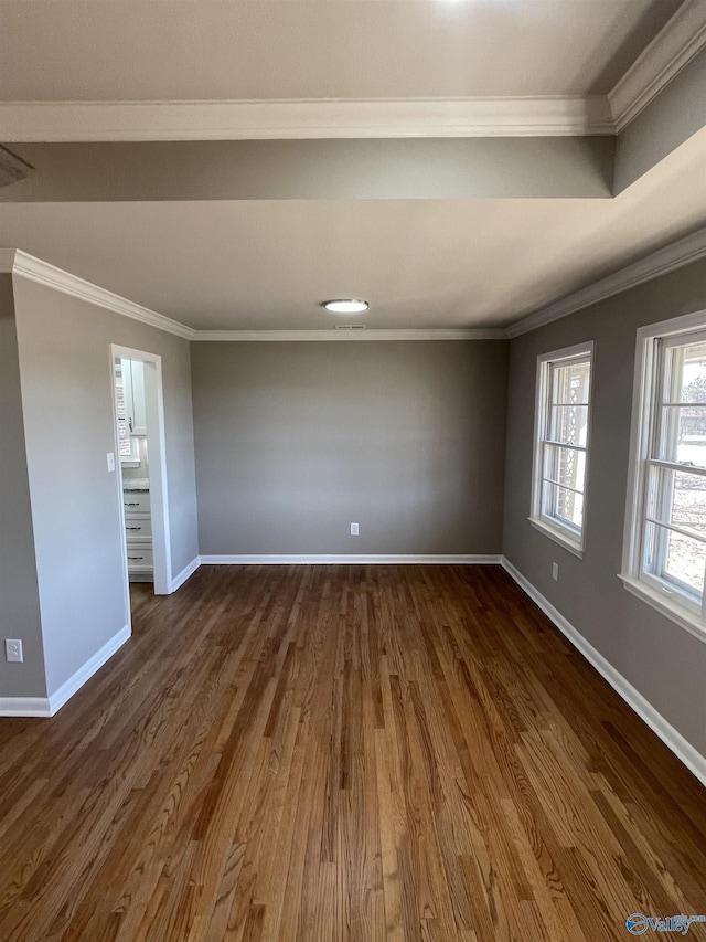 empty room with crown molding, baseboards, and dark wood-type flooring