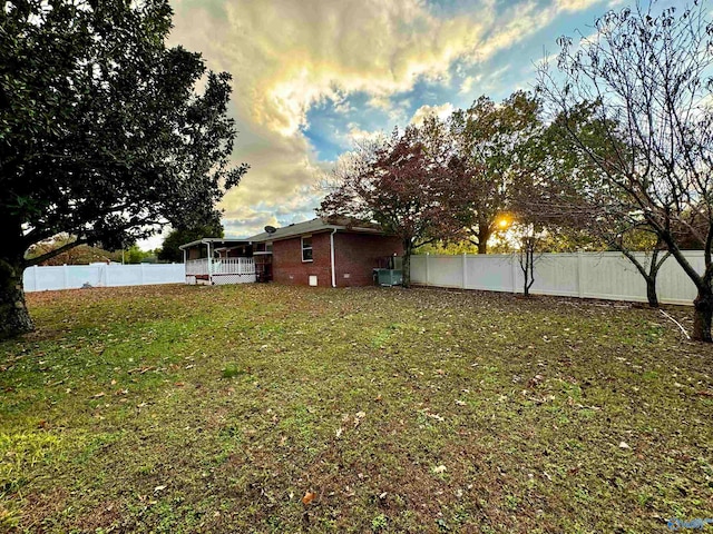 view of yard featuring central AC unit and a fenced backyard