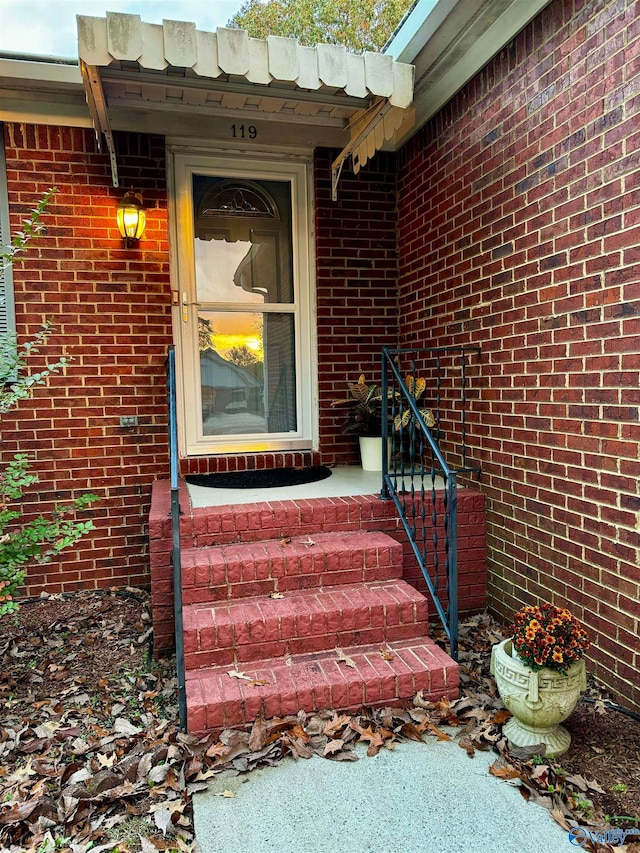 property entrance featuring brick siding