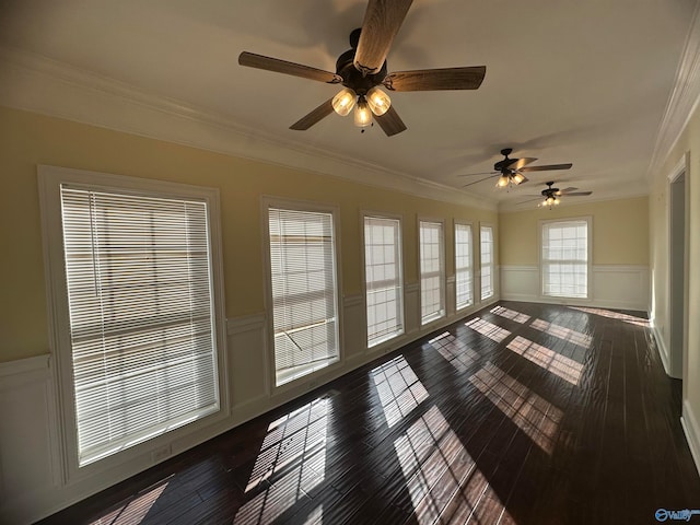 unfurnished sunroom with ceiling fan