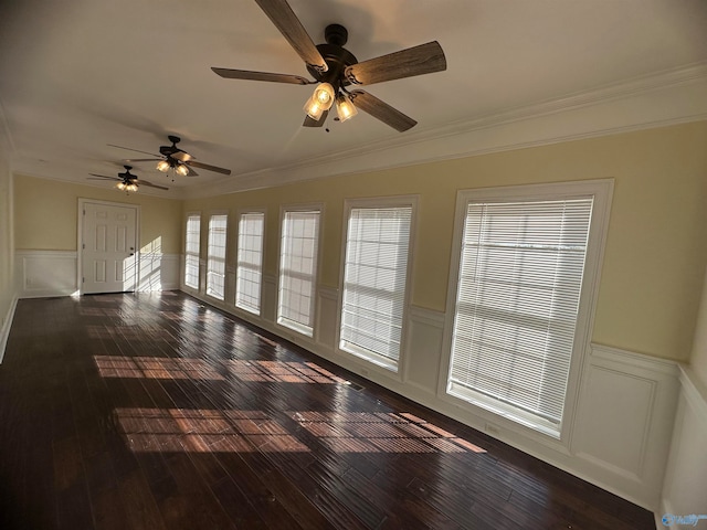 empty room with crown molding and dark hardwood / wood-style floors