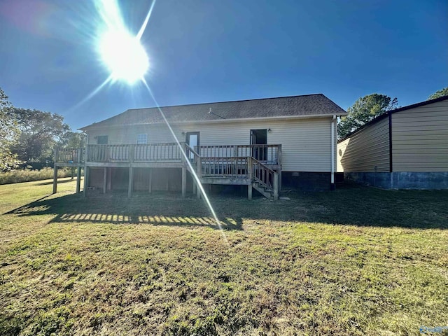 back of property with a lawn, a deck, stairway, and crawl space
