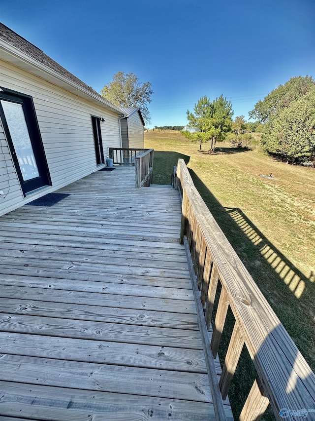 wooden terrace with a lawn