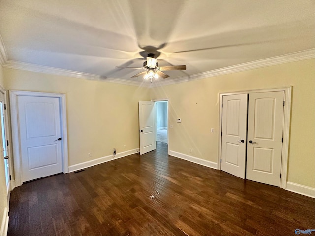 unfurnished bedroom with dark hardwood / wood-style flooring, ornamental molding, and ceiling fan