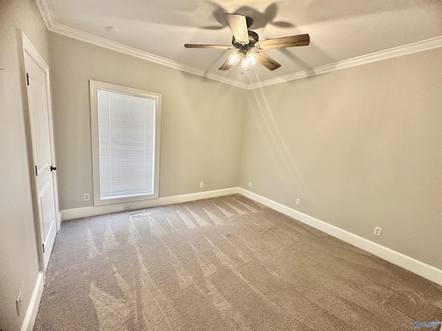 unfurnished room featuring baseboards, ornamental molding, carpet, and a ceiling fan