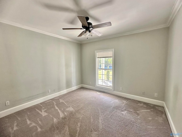 carpeted spare room featuring crown molding and ceiling fan