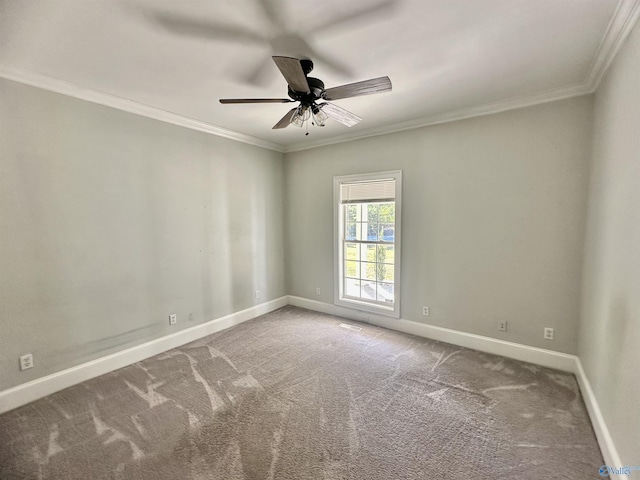 carpeted spare room with baseboards, ornamental molding, and ceiling fan