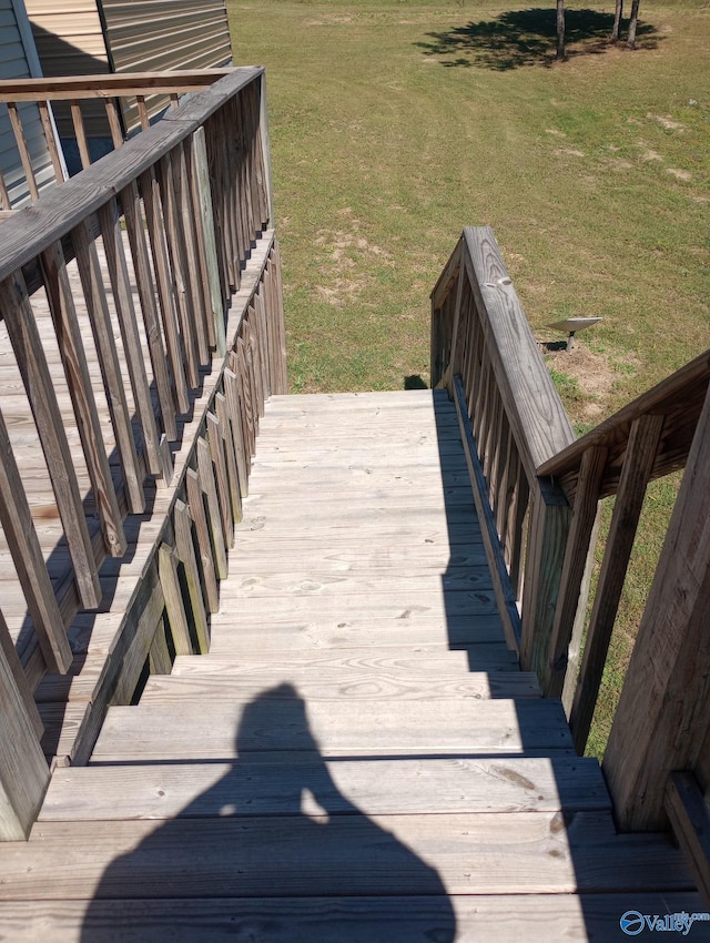 wooden deck featuring a lawn