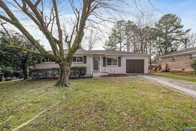 ranch-style home with a garage and a front lawn