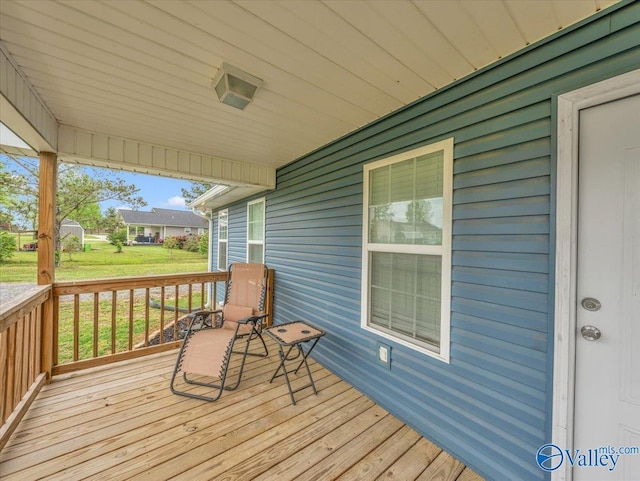 wooden deck with a lawn