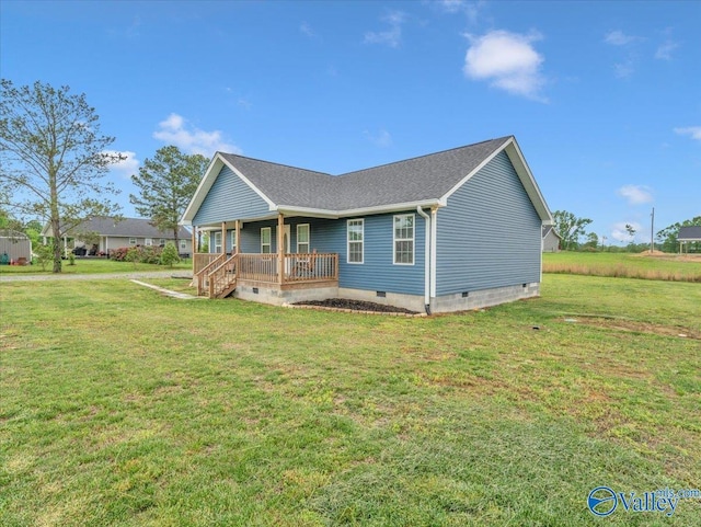 ranch-style home with covered porch, a shingled roof, a front yard, and crawl space