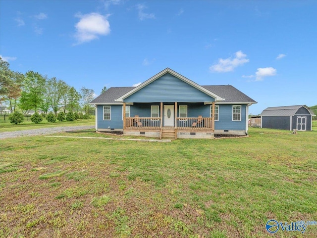 view of front of property featuring an outbuilding, a storage shed, covered porch, a front yard, and crawl space