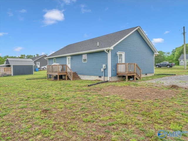 rear view of house featuring a yard, a deck, and crawl space