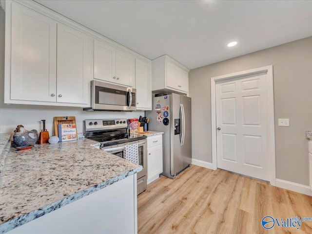 kitchen featuring recessed lighting, appliances with stainless steel finishes, white cabinets, baseboards, and light wood-type flooring