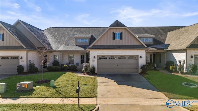 craftsman-style house featuring a garage, a front lawn, and concrete driveway