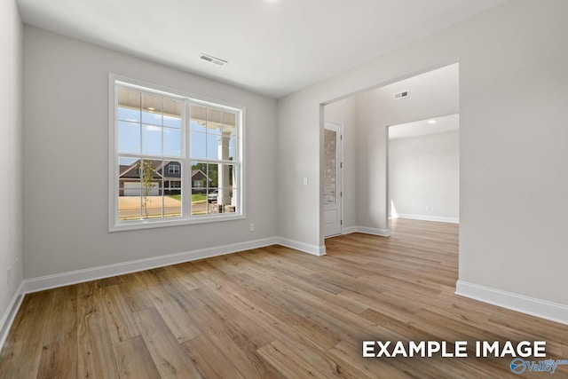 unfurnished room with light wood-type flooring