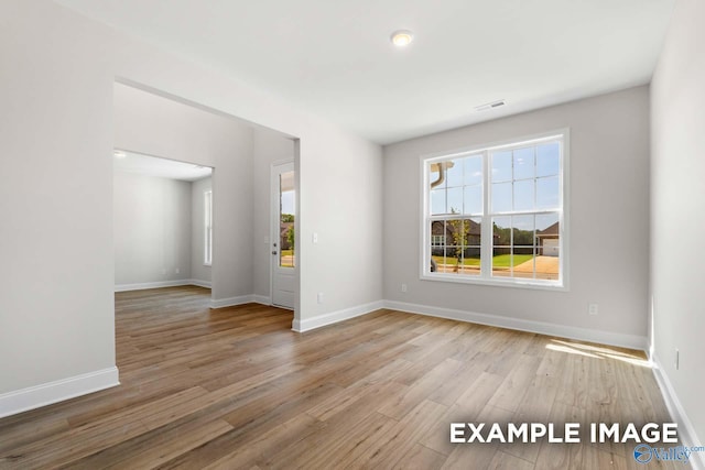 unfurnished room featuring hardwood / wood-style floors