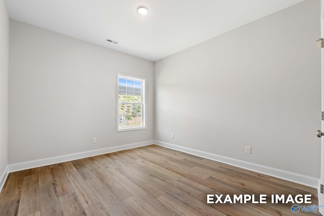 unfurnished room featuring light hardwood / wood-style floors