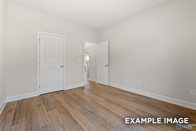 empty room with light hardwood / wood-style flooring