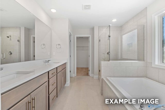 bathroom with tile patterned floors, vanity, and separate shower and tub