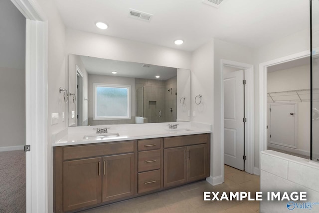 bathroom featuring vanity and an enclosed shower